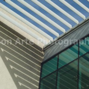 Minimalist architecture photography with emerald glass and chevron shadows at Swansea Marina by Bon Arte Photography