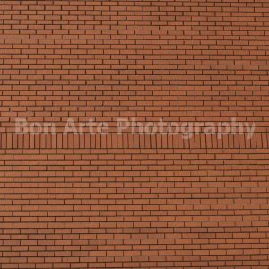 Minimalist red bricks texture wall with horizontal rows and a central vertical row for alternative music album cover design by Bon Arte Photography.