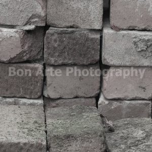 A gritty urban crime book cover stock photo featuring stacked traditional vintage red bricks with terracotta tones and green moss for thriller or fiction design by Bon Arte Photography.